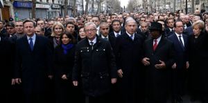 French President Hollande is surrounded by heads of state as they attend the solidarity march in the streets of Paris